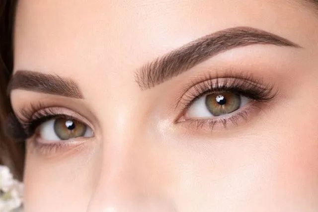 Eyebrow threading in a salon, highlighting the beauty treatment process