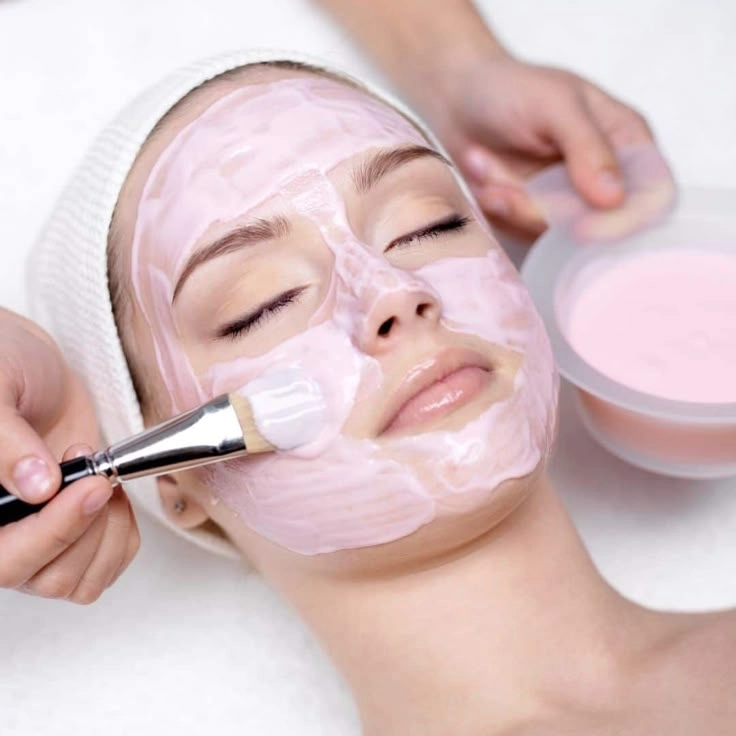 Pink jelly facial mask application during acne hydromedic treatment
